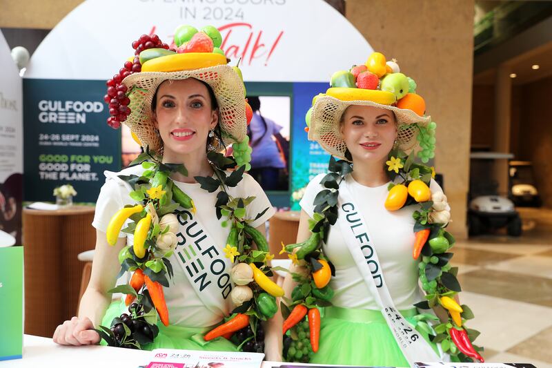 Models wear artificial fruits and vegetables.