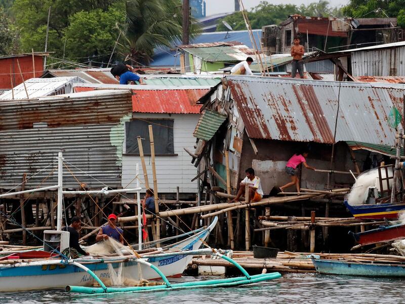Filipino villagers reinforce their homes in anticipation of Typhoon Vongfong at a coastal village in Cavite, Philippines.  EPA