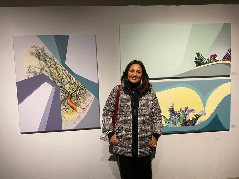 Nevine Hamza with her acrylic and oil on canvas works 'Healer', 'A Dialogue' and 'Unleash'.