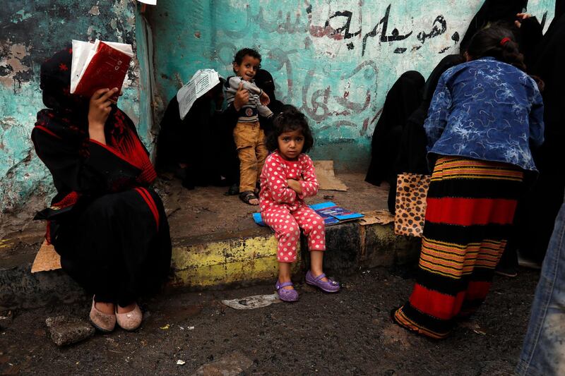 epa08401645 Yemenis wait to get free food rations from a charity group in Sana'a, Yemen, 04 May 2020. According to reports, nearly 80 percent of Yemen's 27 million-population rely on humanitarian aid while half of the population faces famine due to a prolonged conflict that triggered what is considered to be the world's worst humanitarian crisis.  EPA/YAHYA ARHAB