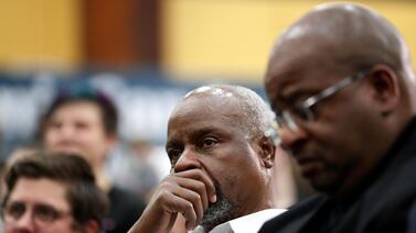 Supporters of US Democratic presidential candidate Bernie Sanders listen to a panel on African-American issues during a town hall in Flint, Michigan