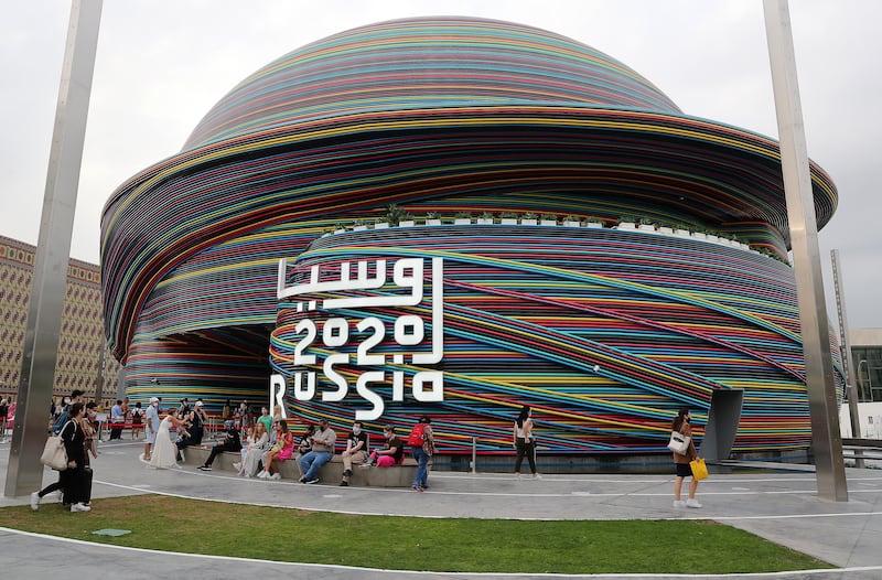 Visitors outside the Russia pavilion, which was closed for some time to repair rain damage.