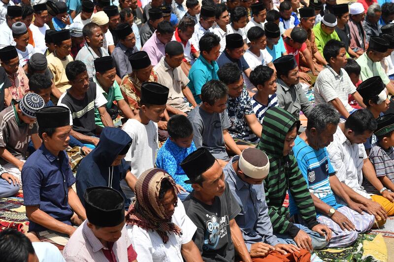 Indonesian Muslims perform congregational Friday prayers on a field near temporary shelters in Pemenang, northern Lombok.  AFP