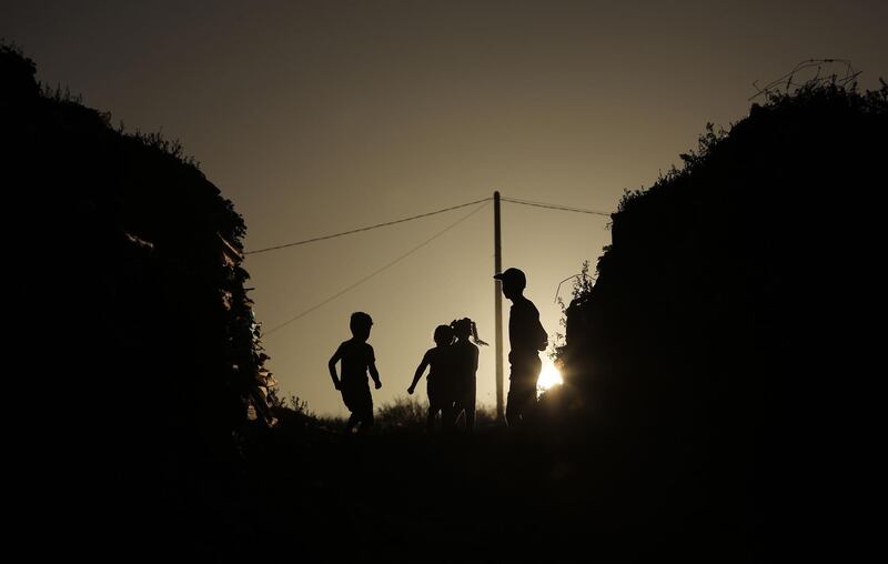 Palestinian children play in the southern Gaza Strip refugee camp of Khan Yunis.   AFP