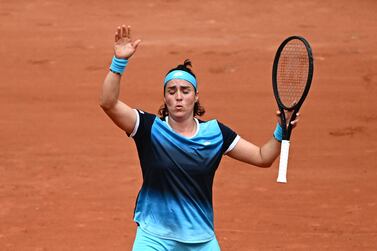 Tunisia's Ons Jabeur reacts as she plays against Poland's Magda Linette during their women's singles match on day one of the Roland-Garros Open tennis tournament at the Court Philippe-Chatrier in Paris on May 22, 2022.  (Photo by Anne-Christine POUJOULAT  /  AFP)
