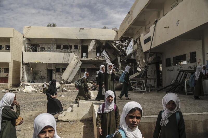 Students of Al Munadhil school for girls in Sanaa, Yemen. The school has been partially destroyed in fighting.  Asmaa Waguih / EPA

