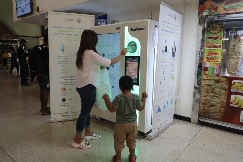 Commuters get points each time they deposit plastic bottles in a reverse-vending machine installed at Abu Dhabi’s main bus terminal. Nilanjana Gupta / The National