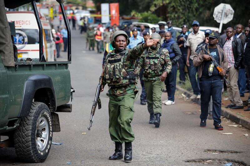 epa07288747 A Kenyan police officer tries to control the crowd outside the business complex in Nairobi, Kenya, 16 January 2019, a day after the attackers stromed the compound killing several people in an attack claimed by Somalia's Islamist militant group al-Shabab. Kenyan President Uhuru Kenyatta said 14 people were killed in an attack and security forces have 'neutralised' all attackers.  EPA/DAI KUROKAWA