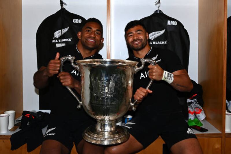 Richie Mo'unga, right, and Sevu Reece celebrate with the Bledisloe Cup. Getty