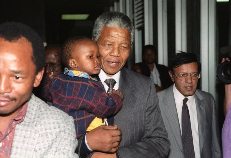 African National Congress (ANC) Deputy-President Nelson Mandela holds his grandson Bambata November 9, 1990 as he arrives back at Johannesburg's Jan Smuts airport from an 18-day fundraising tour of the Far East, Australia, France and Britain.  Reuters/Ulli Michel