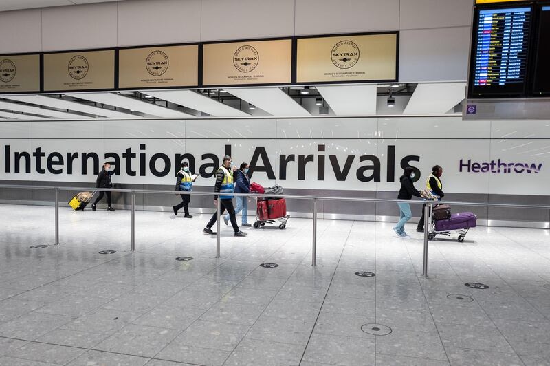 Passengers travelling from 'red list' countries are escorted through the arrivals area of terminal 5 of Heathrow airport and onto a coach, on February 16, 2021. Getty Images