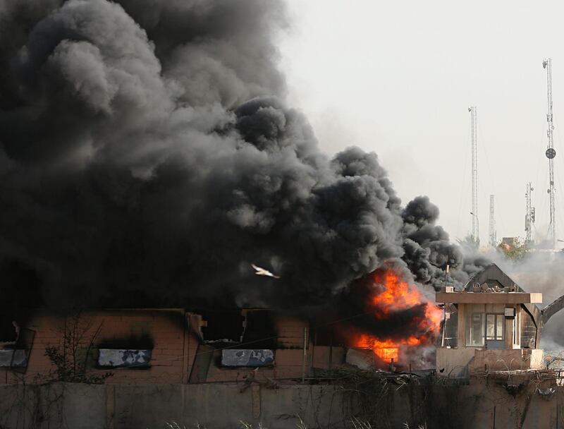 Plumes of smoke rise after a fire broke out at Baghdad's largest ballot box storage site, where ballots from Iraq's May parliamentary elections are stored, in Baghdad, Iraq. Hadi Mizban / AP Photo