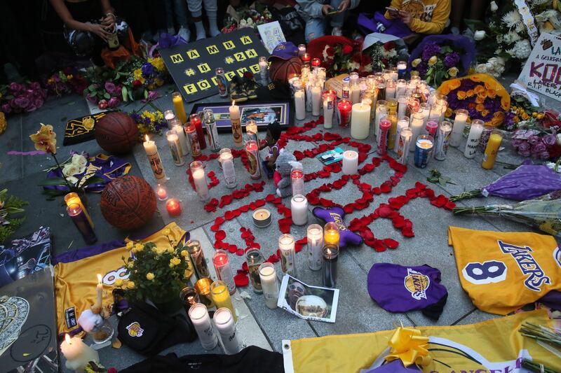 Fans place flowers, candles and memorabilia  during a vigil for late Los Angeles Lakers guard Kobe Bryant, at the LA Live entertainment complex across the street from the Staples Center, home of the Los Angeles Lakers, in Los Angeles, California, USA.  EPA