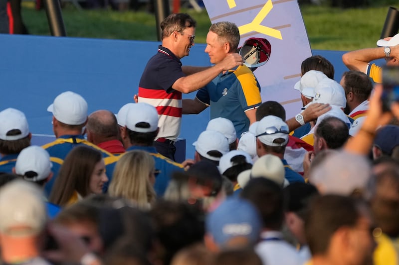 United States' captain Zach Johnson, left, embraces Europe's captain Luke Donald during the presentation ceremony. AP
