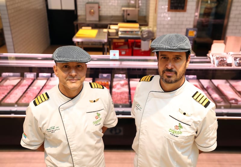 Michiel Smit (R) and Jerome Stubbs. A group of South African pilots on unpaid leave for more than a year become specialist butchers at the Organic Cafe in Dubai on May 30th, 2021. Chris Whiteoak / The National. 
Reporter: Kelly Clark for News