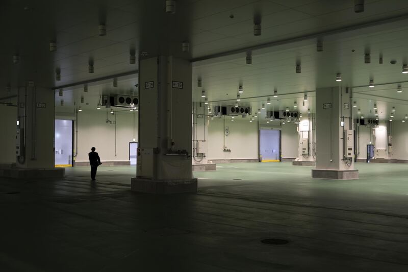 A member of the media walks through the auction area at Toyosu Market in Tokyo, Japan, The Toyosu Market, where the iconic Tsukiji fish market will relocate to.