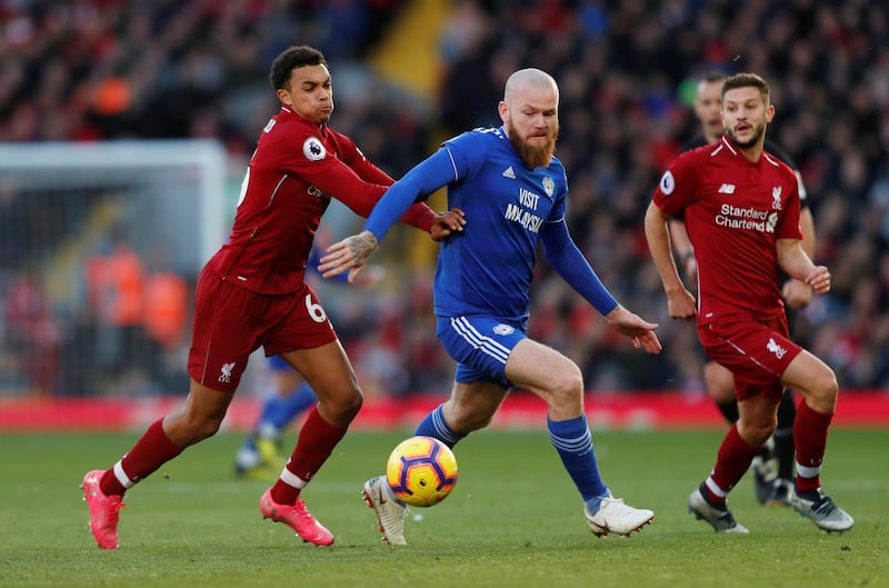 Cardiff City's Aron Gunnarsson in action with Liverpool's Trent Alexander-Arnold and Adam Lallana. Reuters