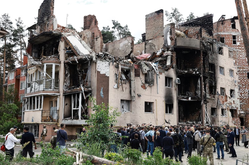 They visited a building damaged in fighting near Kyiv. Reuters