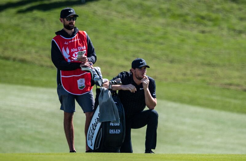 Thomas Pieters and his caddie Adam Marrow look on from the second fairway. AFP