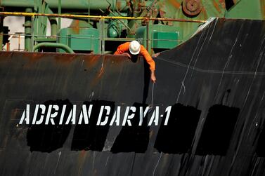 A crew member checks the new name of Iranian oil tanker Grace 1. Reuters