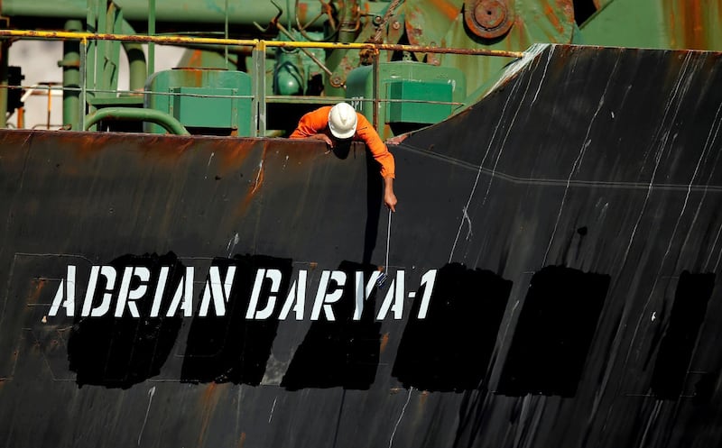 FILE PHOTO: A crew member takes pictures with a mobile phone on Iranian oil tanker Adrian Darya 1, previously named Grace 1, as it sits anchored after the Supreme Court of the British territory lifted its detention order, in the Strait of Gibraltar, Spain, August 18, 2019. REUTERS/Jon Nazca/File Photo