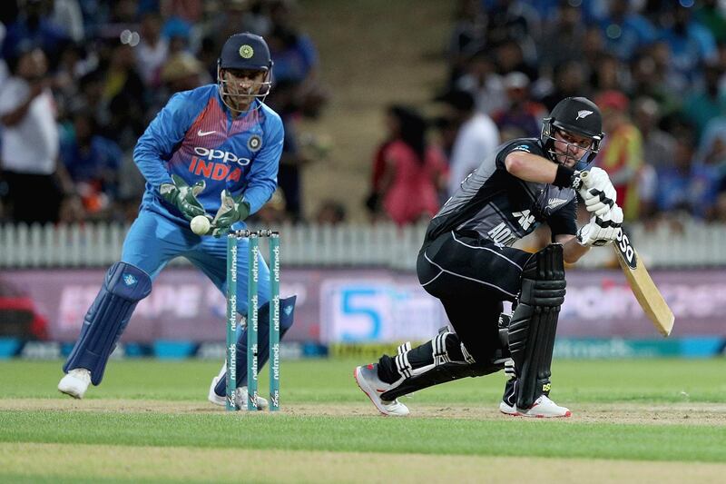 New Zealand's Colin Munro bats and is fielded by India's wicketkeeper MS Dhoni during their twenty/20 cricket international at Seddon Park in Auckland, New Zealand, Sunday, Feb. 10, 2019. (AP Photo/David Rowland)