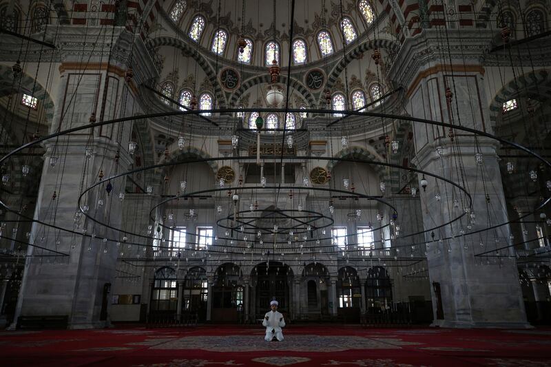 Esat Sahin, Imam of the iconic Fatih Mosque, holds a prayer held without public due to the coronavirus restrictions in Istanbul, April 24, 2020, during the first day of the holy fasting month of Ramadan. (AP Photo/Emrah Gurel)