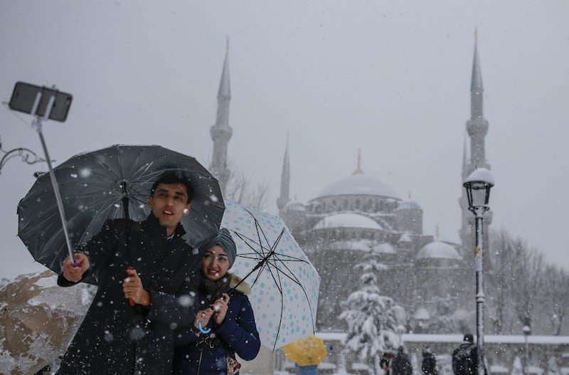 A couple takes a selfie in the Sultanahmet district, one of Istanbul's main tourist attractions on January 9, 2017. Tourism has been affected by the spate of terror attacks in Turkey, causing some residents to be wary and afraid of going out. Emrah Gurel/AP Photos