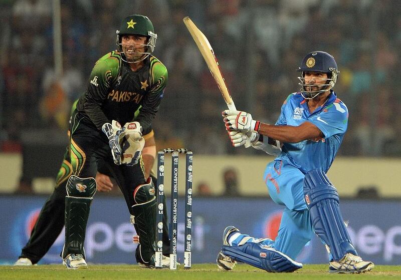 India's Shikhar Dhawan plays a sweep during the T20 World Cup match against Pakistan at the Sher e Bangla National Stadium in Dhaka on March 21, 2014. AFP