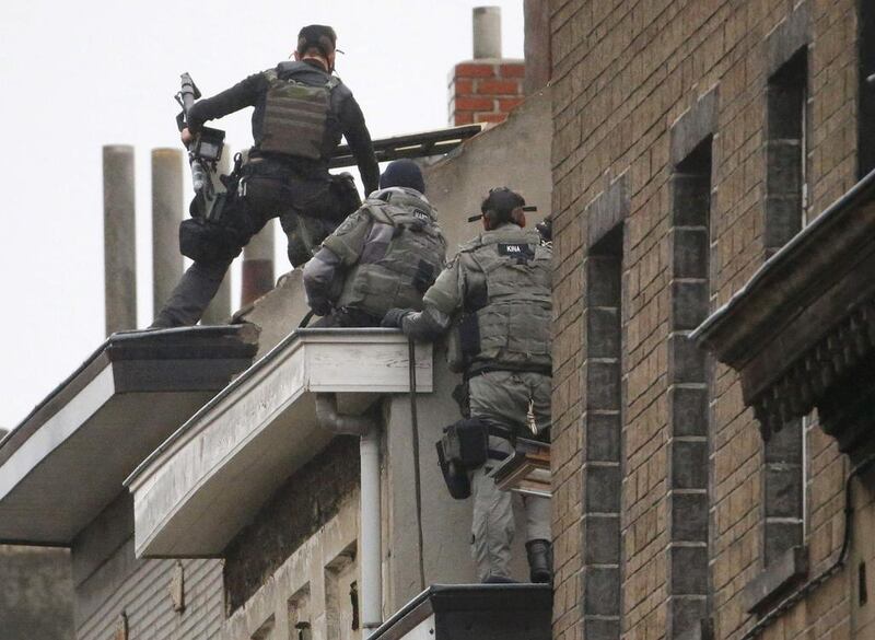 Belgian special forces climb an apartment block in the Brussels suburb of Molenbeek during a raid on November 16, 2015, in search suspects linked to the deadly attacks in Paris. Yves Herman / Reuters