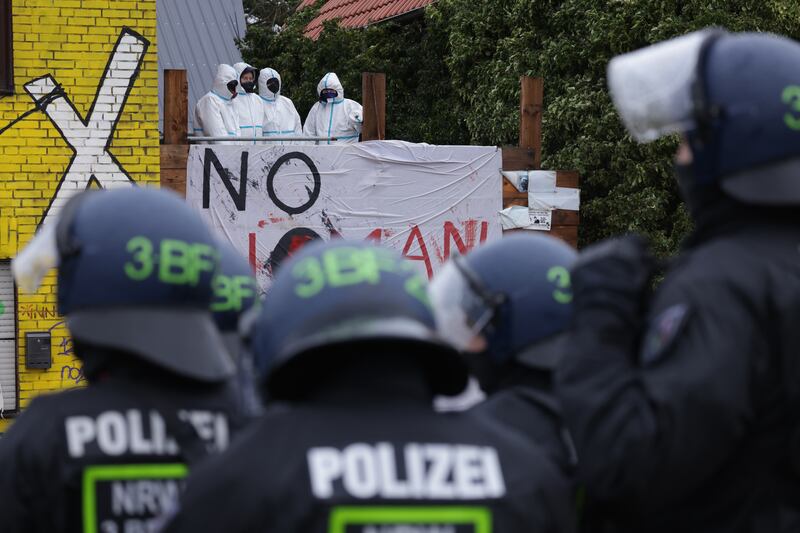 Riot police gather in front of environmental activists occupying a house in the village of Luetzerath, western Germany. Getty