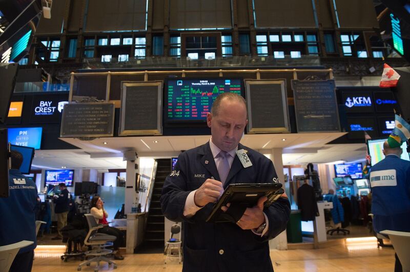 Traders work on the floor at the closing bell of the Dow Industrial Average at the New York Stock Exchange on March 8, 2018 in New York. 
US stocks finished a volatile session higher Thursday after President Donald Trump enacted controversial tariffs on imported steel and aluminum amid worries the move could ignite a global trade war. The Dow Jones Industrial Average advanced 0.4 percent to 24,895.21. The broad-based S&P 500 gained 0.5 percent to 2,738.97, while the tech-rich Nasdaq Composite Index increased 0.4 percent to 7,427.95.
 / AFP PHOTO / Bryan R. Smith