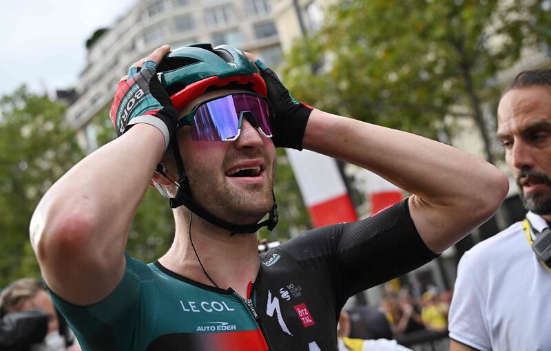 Belgian rider Jordi Meeus celebrates after winning Stage 21 with his teammates. AFP