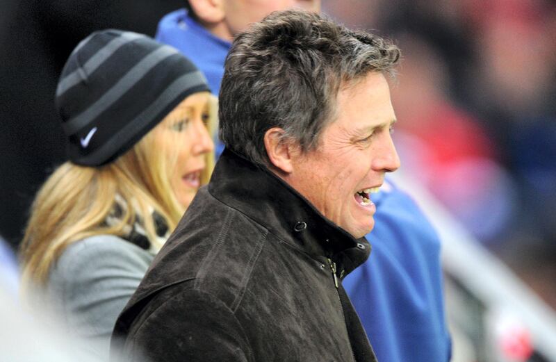 British actor Hugh Grant attends the final football match of the UEFA Europa League Fulham FC vs Aletico Madrid in Hamburg, northern Germany on May 12, 2010. AFP PHOTO / NIGEL TREBLIN (Photo by NIGEL TREBLIN / AFP)