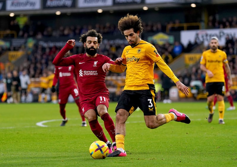 Liverpool's Mohamed Salah battles with Rayan Ait-Nouri. PA