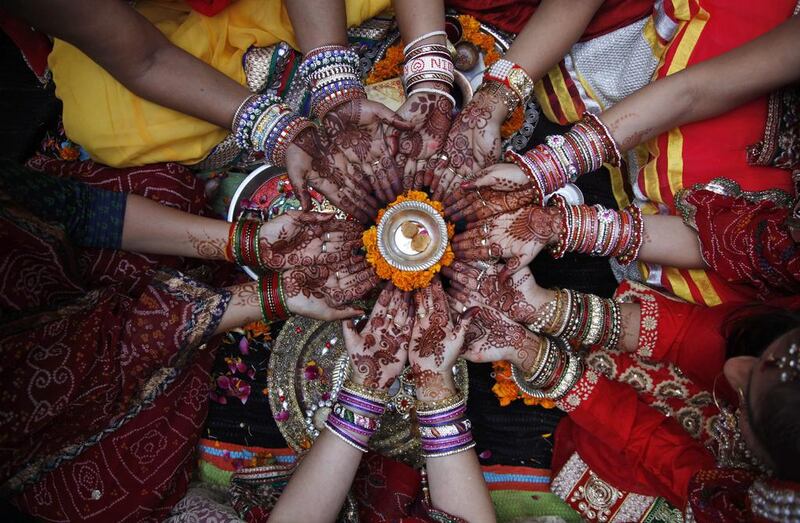 Hindu women perform rituals during Karva Chauth festival in Ahmadabad.  AP Photo
