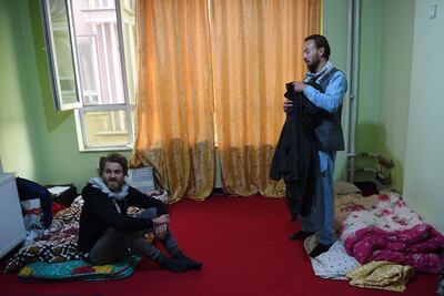 In this photo taken on November 11, 2018, Norwegian tourist Jorn Bjorn Augestad (L), 29, and Dutch tourist Ciaran Barr (R), 24, talk with Afghan Couchsurfing host Naser Majidi (unseen), 27, at a house in Kabul.
 Once a popular stop on the well-worn hippy trail between Europe and South Asia in the 1970s, Afghanistan has seen the number of foreign travellers crossing its borders dwindle in the past four decades of almost non-stop conflict. But dozens still make the dangerous journey every year, ignoring clear warnings from their own governments to stay away from a country infested with suicide attackers, kidnappers and armed robbers, and which by some estimates is now the world's deadliest conflict zone.  - TO GO WITH AFP STORY AFGHANISTAN-LEISURE,FEATURE BY ALLISON JACKSON
 / AFP / WAKIL KOHSAR / TO GO WITH AFP STORY AFGHANISTAN-LEISURE,FEATURE BY ALLISON JACKSON
