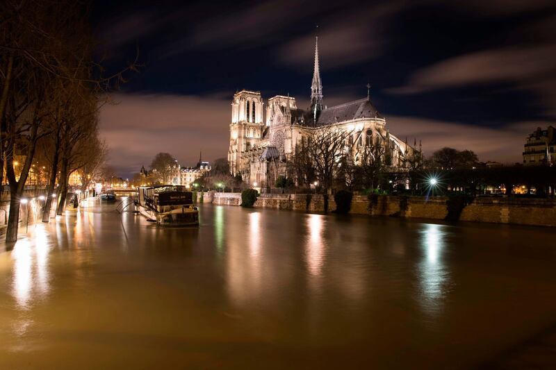 The flooded banks of the Seine river near Notre-Dame Cathedral. The swollen Seine peaked on January 29 at more than four metres above its normal level, leaving a lengthy mop-up job for Parisians after days of rising waters that have put the soggy city on alert.  Joel Saget / AFP