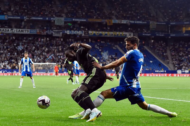 Real Madrid midfielder Eduardo Camavinga attempts to shield the ball from with Espanyol defender Leandro Cabrera. AFP