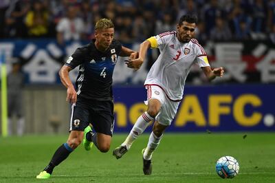 SAITAMA, JAPAN - SEPTEMBER 01: Walid Abbas of United Arab Emirates#3 and Keisuke Honda of Japan#4 compete for the ball during the 2018 FIFA World Cup Qualifiers Group B match between Japan and United Arab Emirates at Saitama Stadium on September 1, 2016 in Saitama, Japan. (Photo by Etsuo Hara/Getty Images)