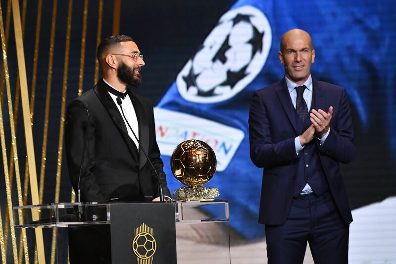 Former Real Madrid manager Zinedine Zidane, right, applauds Karim Benzema after receiving the Ballon d'Or award. Getty Images