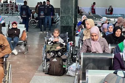 A young cancer patient evacuated from Gaza sits on a wheelchair in the arrivals hall on the Egyptian side of the Rafah border, as he heads to the UAE for treatment. AFP