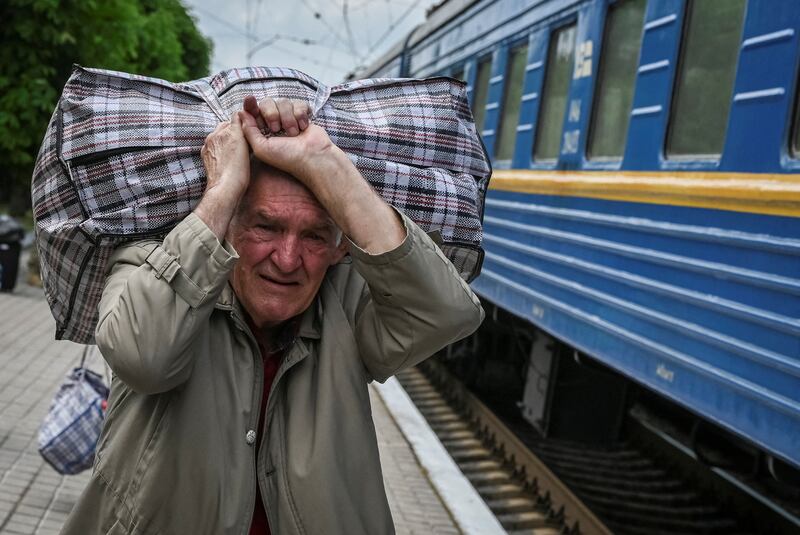 An evacuee from eastern Ukraine boards a train in Pokrovsk bound for Lviv. Reuters