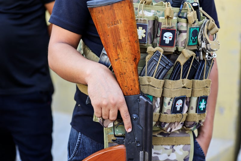 Ready to fight, a member of the Peace Brigade is laden with ammunition in Baghdad. Reuters