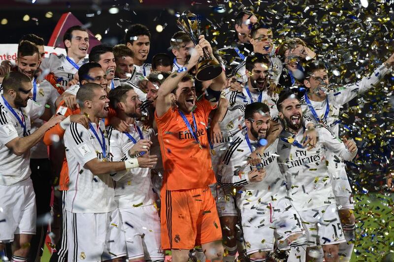 Real Madrid’s players celebrate with the trophy after winning the FIFA Club World Cup final football match against San Lorenzo at the Marrakesh stadium in the Moroccan city of Marrakesh on December 20, 2014. Real Madrid defeated San Lorenzo of Argentina 2-0 to win the Club World Cup and secure their fourth trophy of 2014. AFP PHOTO / JAVIER SORIANO