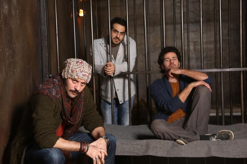 Director Majid Al Ansari, centre, with actors Ali Suleiman, left, and Saleh Bakri on the set of Zinzana. Courtesy Image Nation