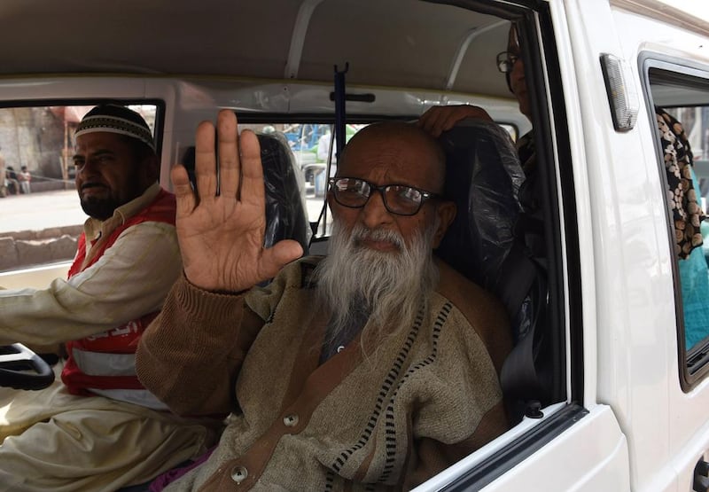 Abdul Sattar Edhi, the head of Edhi Foundation waving as he journeys to his office in the port city of Karachi. Asif Hassan / AFP Photo