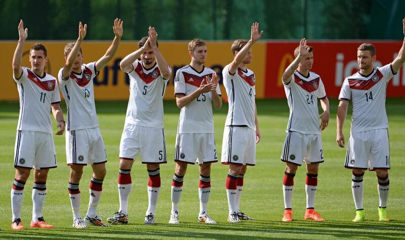 Germany players Miroslav Klose, Thomas Muller, Mats Hummels, Christoph Kramer, Benedikt Howedes, Erik Durm and Shkodran Mustafi wave to fans prior to their training match against the German U-20 side on Sunday. Andreas Gebert / EPA