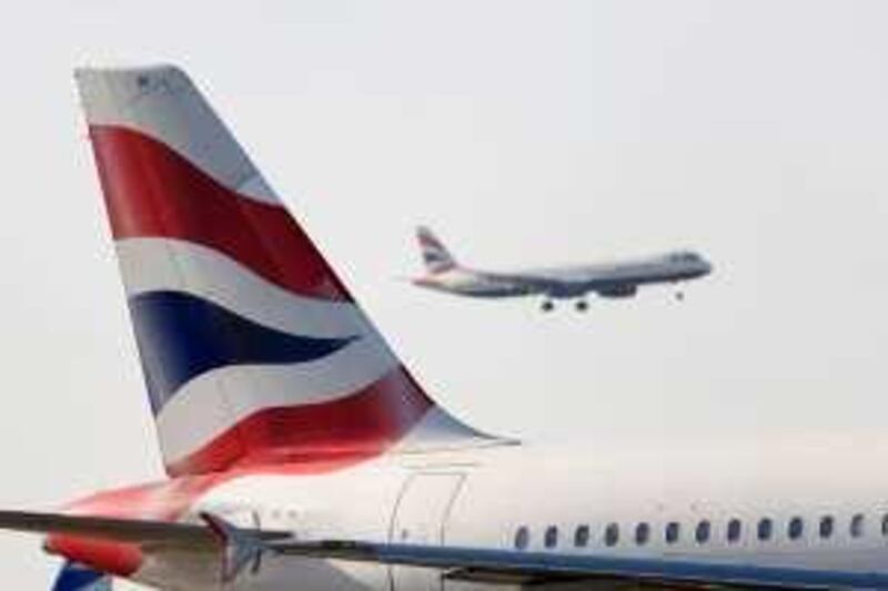 A British Airways aeroplane prepares to land as another aeroplane waits on the runway at Heathrow airport, in London, U.K., on Friday, May 22, 2009. British Airways Plc, Europe’s third- largest carrier, reported its first full-year loss since 2002 and said it will park planes and slash capacity as the global recession restrains demand for air travel. Photographer: Chris Ratcliffe/Bloomberg News