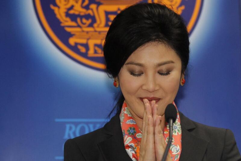 Thailand’s Prime Minister Yingluck Shinawatra gives a traditional greeting as she addresses reporters in Bangkok. A Thai court found Yingluck guilty of violating the constitution on Wednesday and said she had to step down, throwing the country into further political turmoil. Chaiwat Subprasom / Reuters